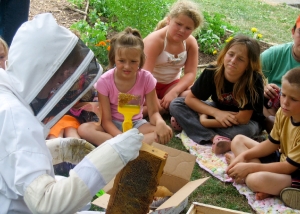 Volunteer Diana Stafford demonstrates beekeeping to local children at Hope Garden. Provided by Liz Shaw.